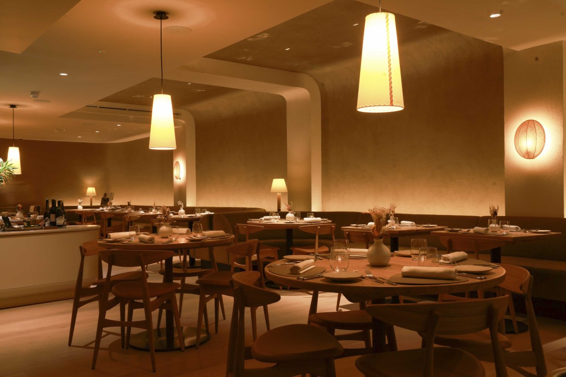 Main restaurant dining space at 74 Charlotte Street featuring Armourcoat Clay Lime Plaster walls, Armourcoat Acoustic Plaster, curved architectural openings and warm pendant lighting.